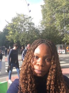 Eucharia looking into the camera with the London Eye visible just behind her